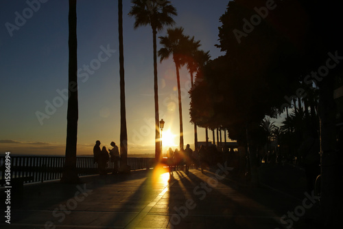 seaside boulevard in Marbella, Spain with colorful lens flares during sunset © chrupka