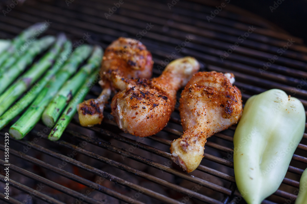 Barbecue chicken leg drumstick with asparagus on grill Barbecue chicken leg drumstick with asparagus on grill