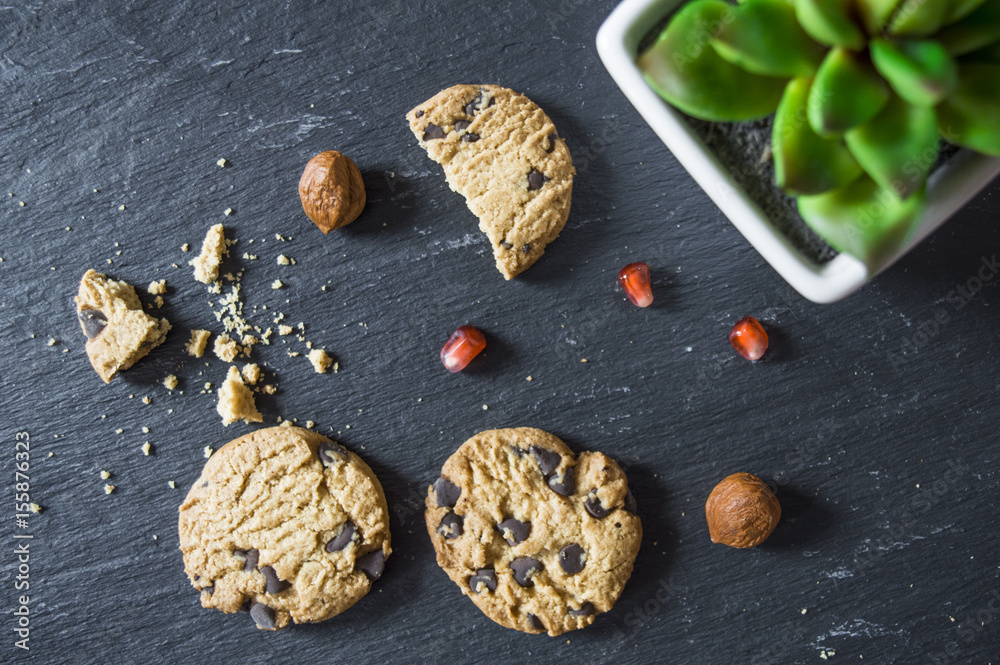 Fototapeta premium Chocolate cookies on dark background. Chocolate chip cookies closeup