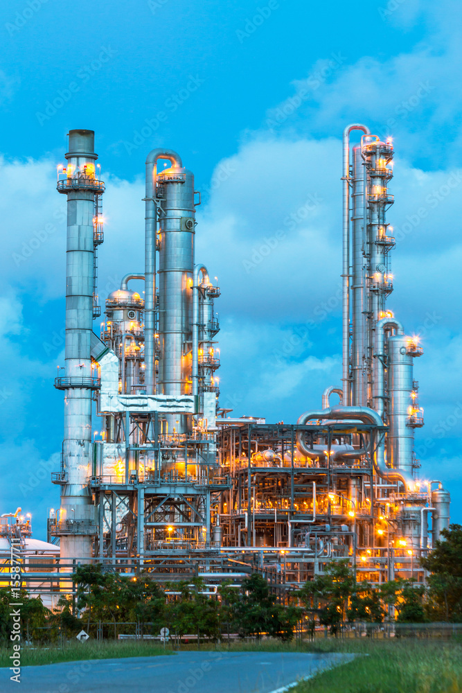 Refinery tower in petrochemical industrial plant with Twilight Refinery tower in petrochemical industrial plant with Twilight