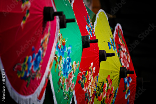 Colorful umbrellas on display at traditional street market.