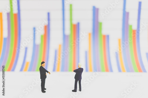 Miniature people businessman standing on  chart