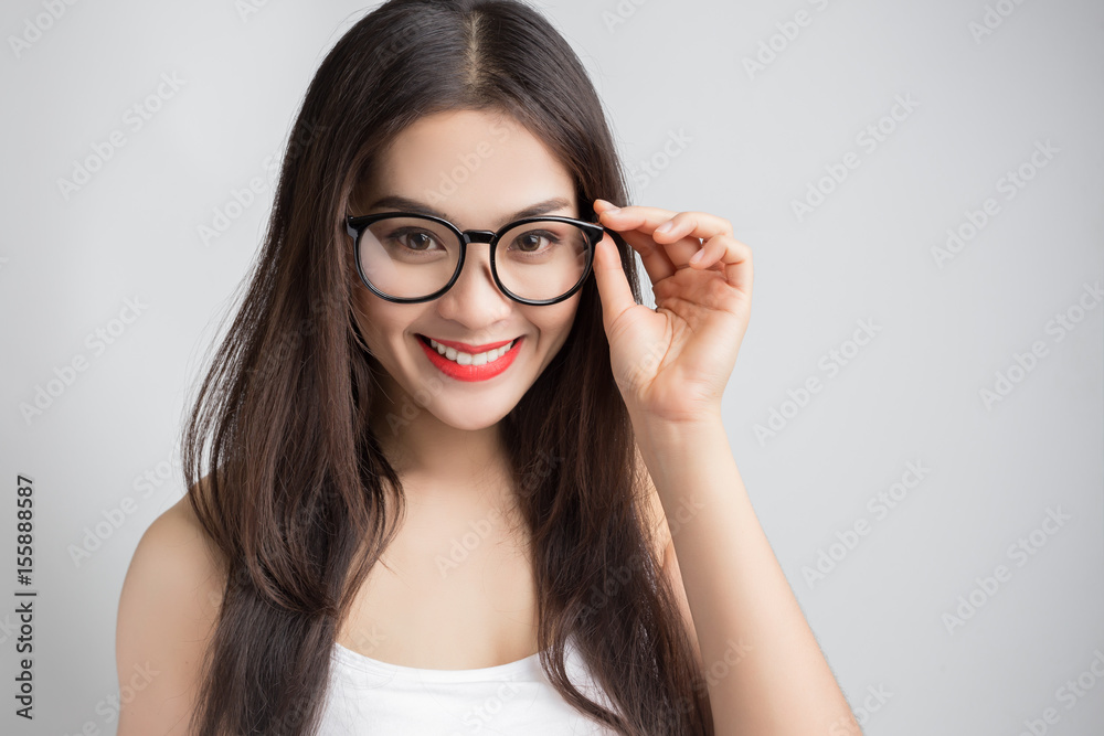 Young beautiful Asian woman with smiley face wearing glasses. Young beautiful Asian woman with smiley face wearing glasses.