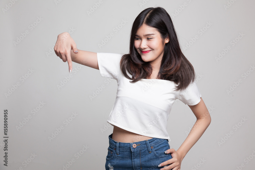 Beautiful young Asian woman point down to blank space. Beautiful young Asian woman point down to blank space.