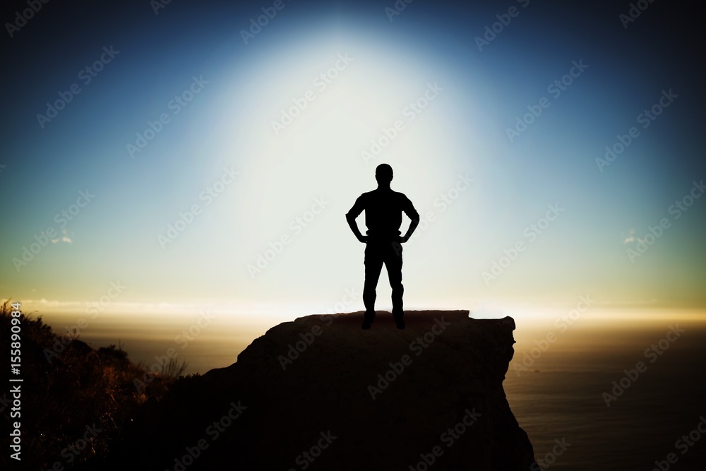 Composite image of businessman standing with hands on hips Composite image of businessman standing with hands on hips