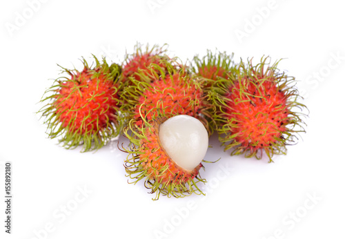 whole and peeled fresh rambutan on white background