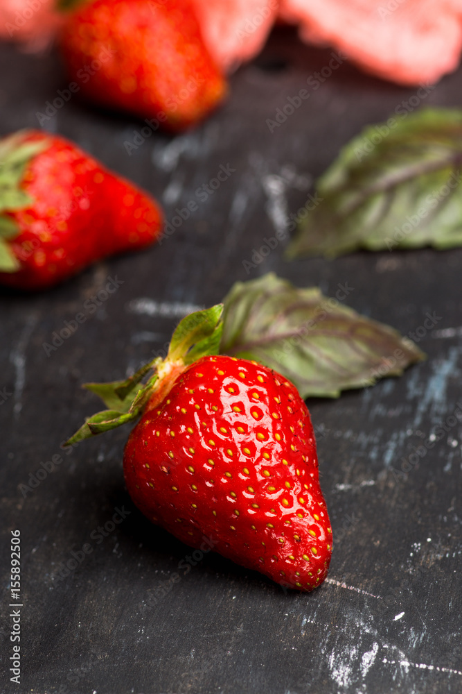 Fresh ripe strawberry on the rustic background. Shallow depth of field. Fresh ripe strawberry on the rustic background. Shallow depth of field.