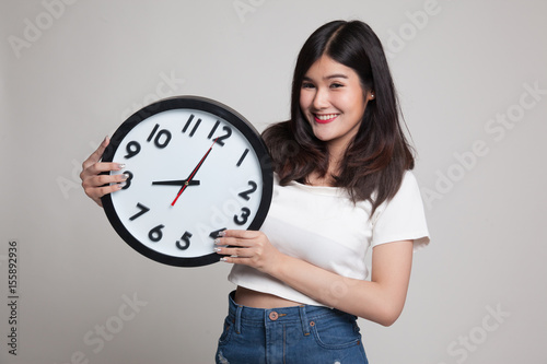 Young Asian woman with a clock.