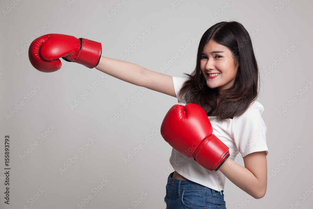 Young Asian woman with red boxing gloves. Young Asian woman with red boxing gloves.