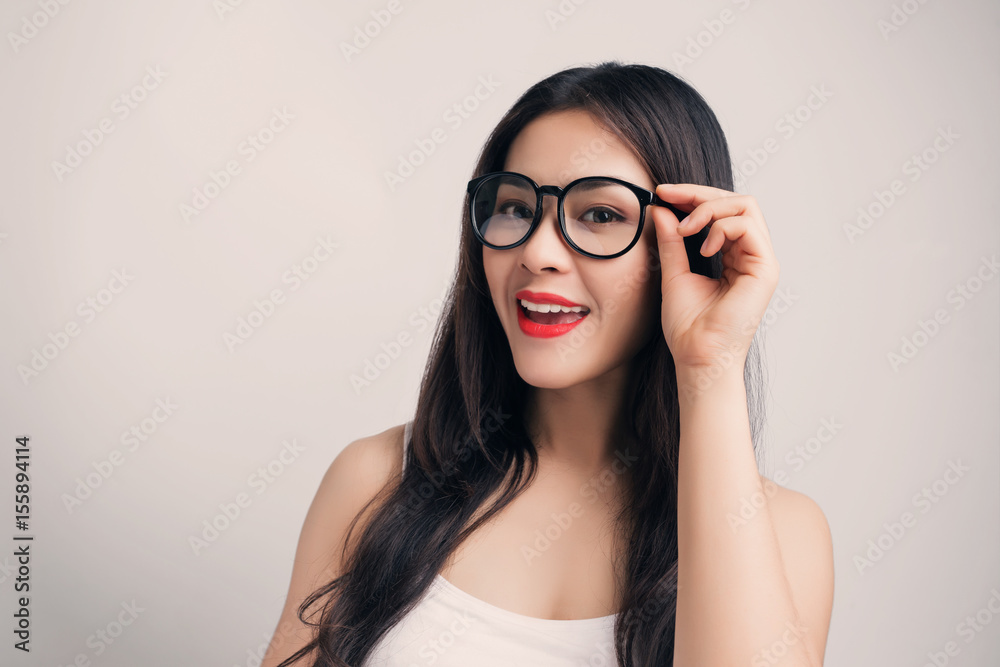 Young beautiful Asian woman with smiley face wearing glasses.