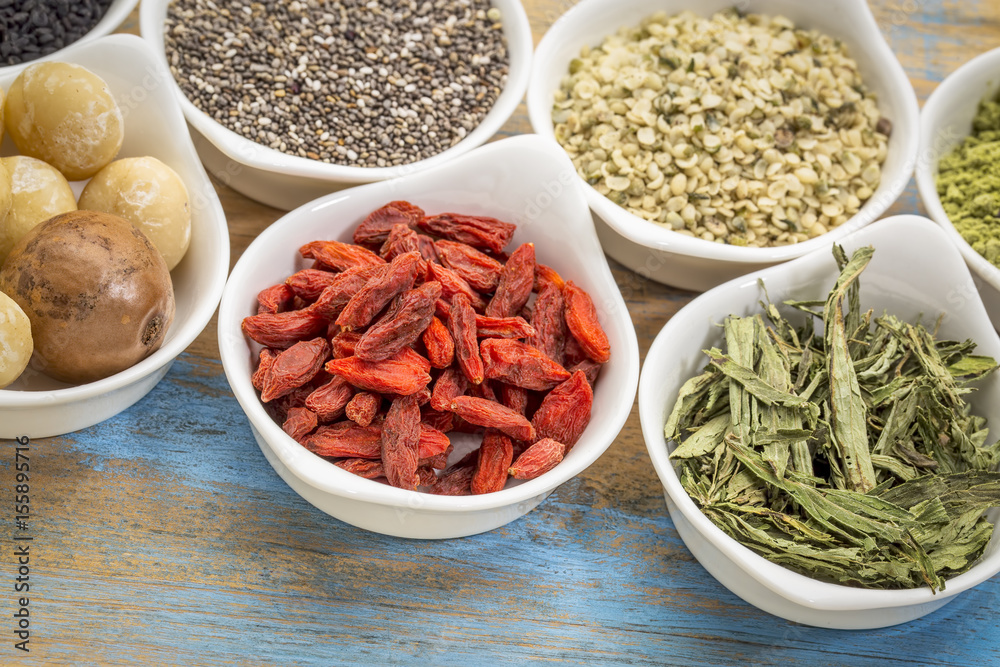superfood set in small bowls against wood superfood set in small bowls against wood