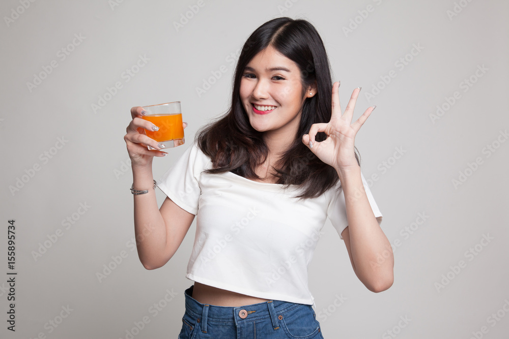 Young Asian woman show OK drink orange juice. Young Asian woman show OK drink orange juice.