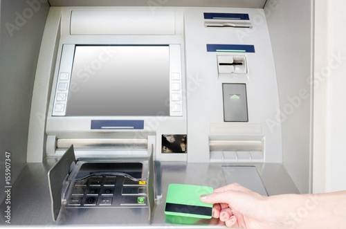 female hand holding a blank card near ATM