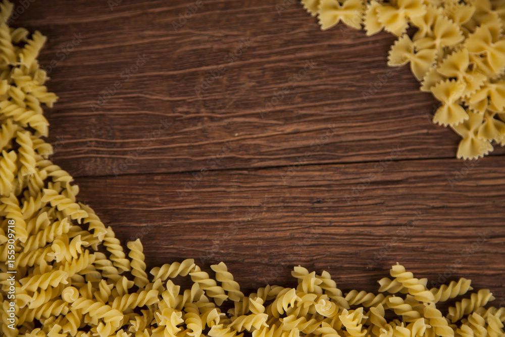 Dry pasta with ingredients on a old wood Dry pasta with ingredients on a old wood