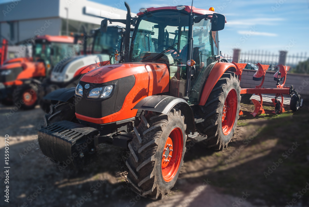 A close-up of a new tractor. Agricultural soil cultivation machine. Concept agro culture. A close-up of a new tractor. Agricultural soil cultivation machine. Concept agro culture.