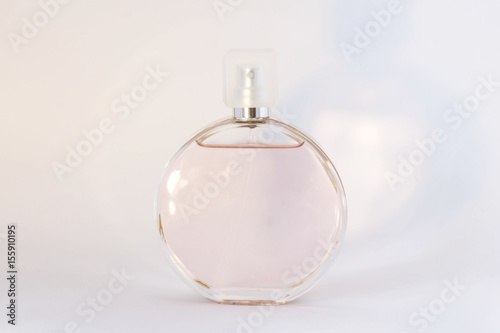 Bottle of perfume on a white background with light shade, grace and freshness, copy space. Concept beauty and fashion.