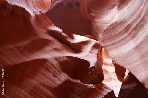 Nature red sandstone textured background good for wallpaper. Swirls of old red sandstone wall abstract pattern in Lower Antelope Canyon, Page, Arizona, USA.