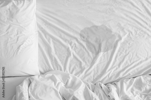 Pee on a bed mattress,Bedwetting sleep enuresis in Adults or baby concept ,selected focus at wet on the bed sheet photo