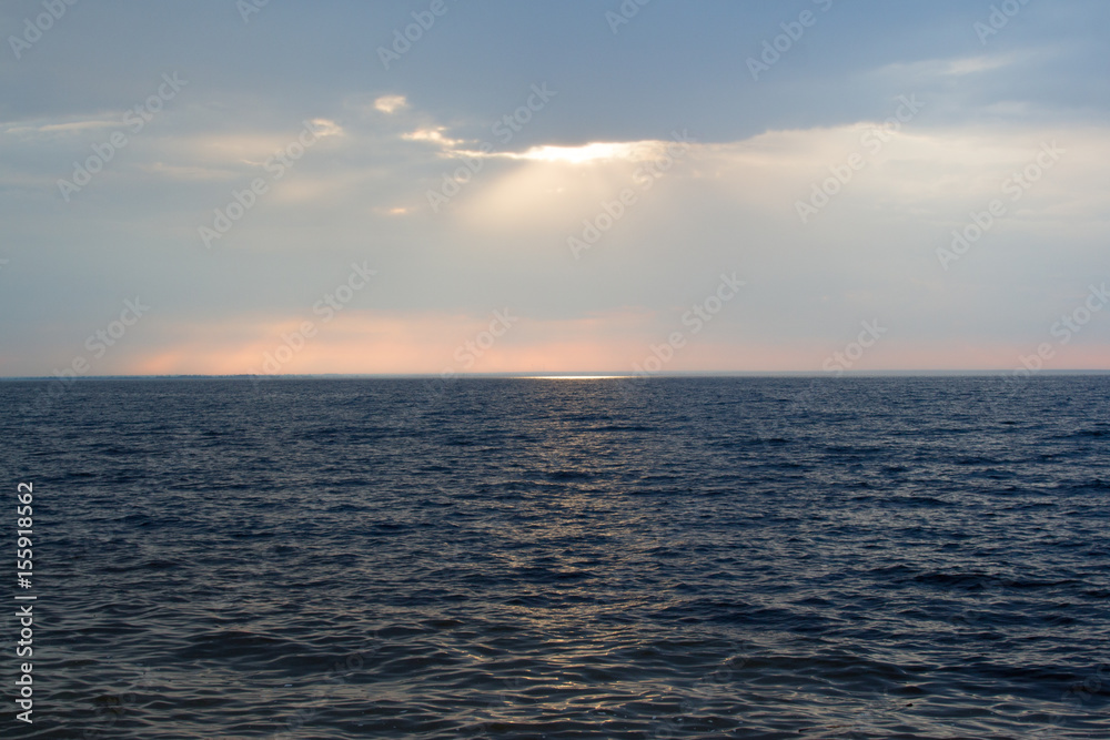 Sea sunset, in warm tones on a rocky shore