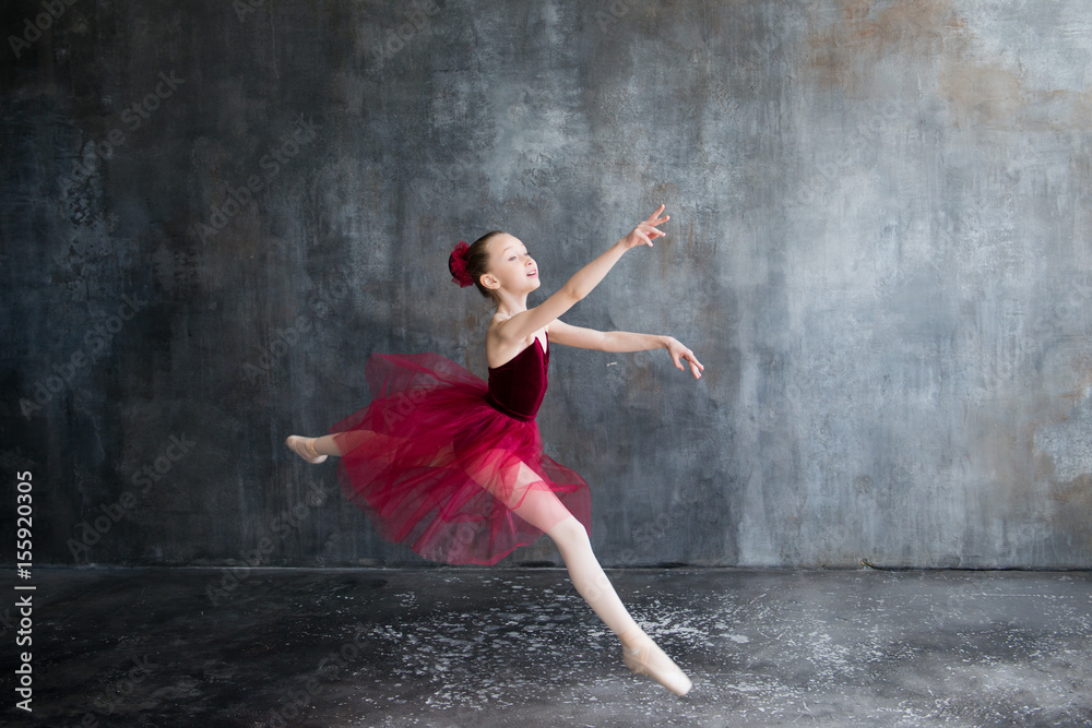 girl ballerina in red tutu doing exercise