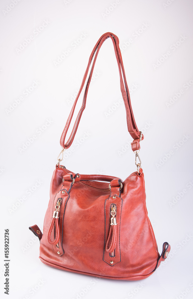bag or brown leather woman handbag on background.