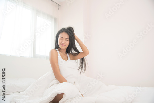 Beautiful Asian woman waking up in the morning. © eggeeggjiew