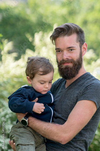 Young hipster father holding his little son in park © cineberg