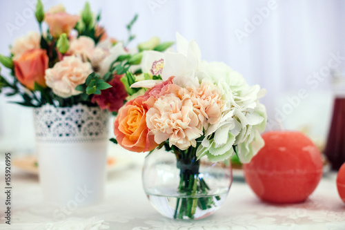 flowers in the vase on the banquet table