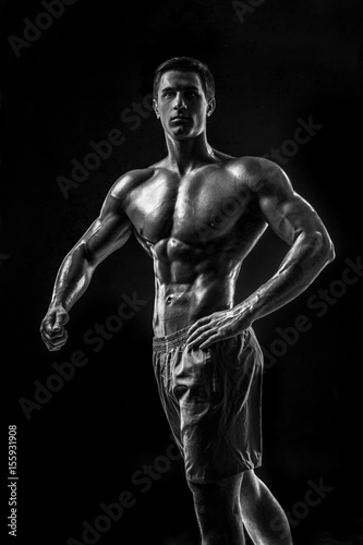Muscular and fit young bodybuilder fitness male model posing ove © nazarovsergey