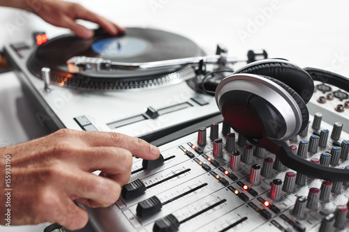 a person playing records and using a mixing board