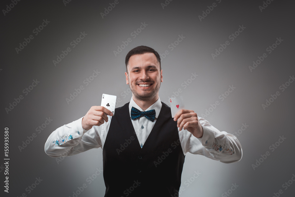 Handsome confident man holding cards looking at camera. Handsome confident man holding cards looking at camera.