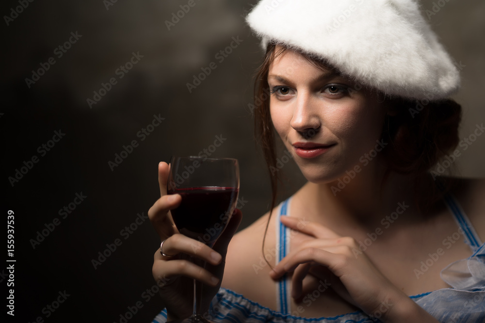 A glass of wine and a portrait of a beauty with a beret. A glass of wine and a portrait of a beauty with a beret.