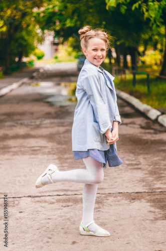 Positive little girl. Fancy Hairstyle. Sincere smile. summer weather