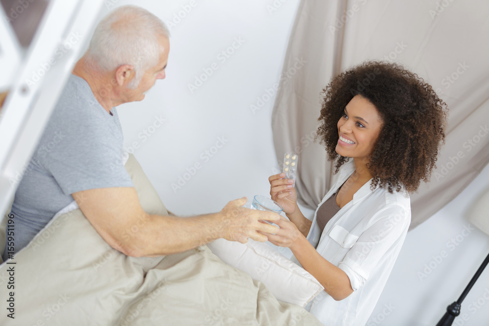 Obraz premium Carer administering medication to patient