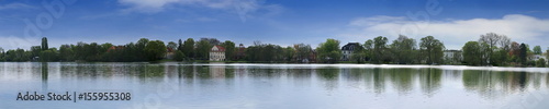 Panorama of a countryside landscape in clear weather with a large lake, trees and houses. Panorama of the Heiliger lake in Potsdam, Germany.