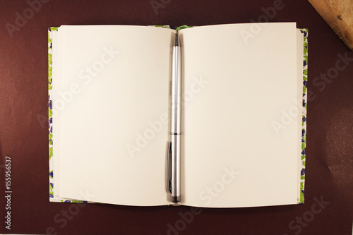 Wallpaper Mural Pen and notepad isolated on a leather background. Pen and notebook on brown leather. View from above. A symbol of journalism, poetry, writers and creators. Torontodigital.ca