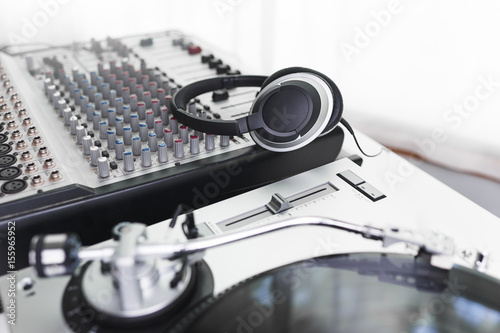 headphones sitting on a mixing board in a recording studio