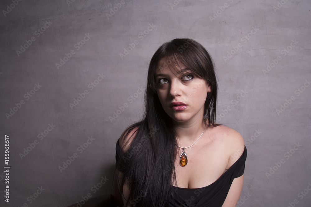 Woman in off the shoulders black dress - close Woman in off the shoulders black dress - close