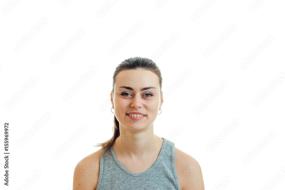 cheerful young cute girl with the ponytail looks straight into the camera and smiling close-up cheerful young cute girl with the ponytail looks straight into the camera and smiling close-up