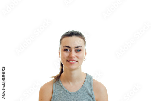 cheerful young cute girl with the ponytail looks straight into the camera and smiling close-up