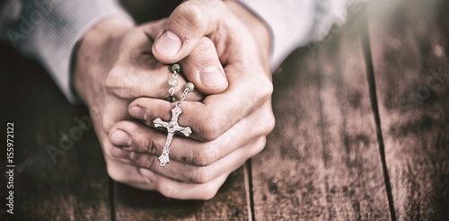 Man praying with rosary