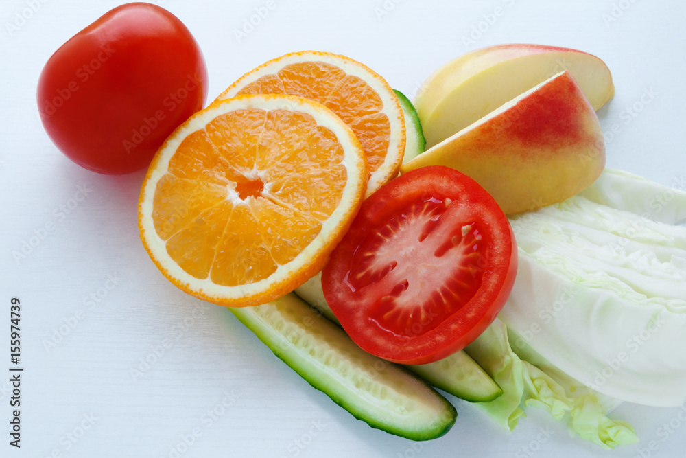 Low Glycemic Index Foods. Apple, orange, tomato, cucumber and cabbage on a white background