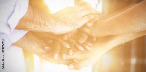 Creative business team stacking hands together