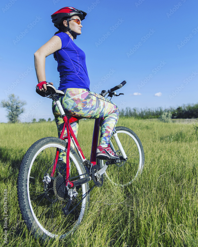 Young Woman Riding Mountain Bike in Wilderness. Young Woman Riding Mountain Bike in Wilderness.