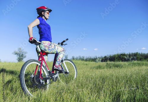 Young Woman Riding Mountain Bike in Wilderness.