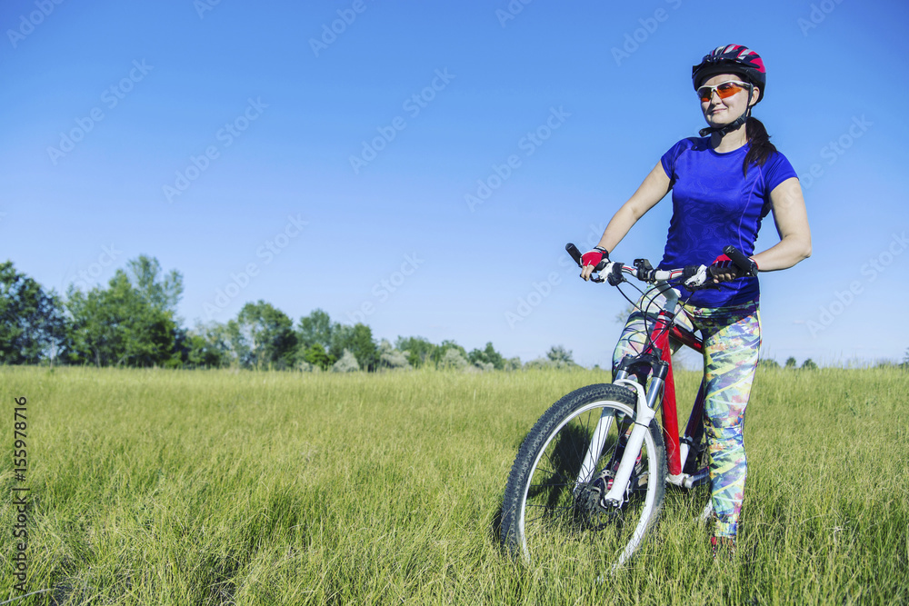 Young Woman Riding Mountain Bike in Wilderness.