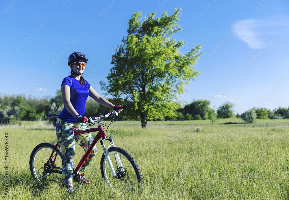 Young Woman Riding Mountain Bike in Wilderness. Young Woman Riding Mountain Bike in Wilderness.