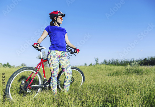 Young Woman Riding Mountain Bike in Wilderness.
