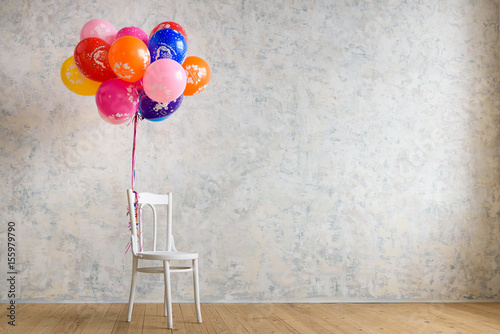 Chair and balloons on the wooden floor in the room photo