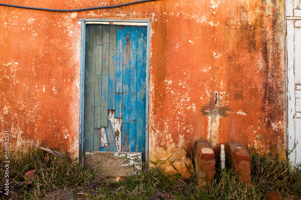 Old blue colored door in abandoned house in countryside